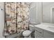 Full bathroom with a vanity, a toilet, a window, and a patterned shower curtain at 398 Carolina Ave, Raleigh, NC 27606