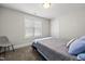 Clean and simple bedroom featuring a bed, a window, and a chair at 398 Carolina Ave, Raleigh, NC 27606