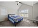 Comfortable bedroom with a ceiling fan, a large window, and a bed with blue covers at 398 Carolina Ave, Raleigh, NC 27606