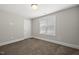 Empty bedroom featuring neutral paint, plush carpet, and a window at 398 Carolina Ave, Raleigh, NC 27606