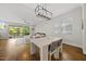 Open-concept dining and living room, bright space with hardwood floors, white walls, and natural light from a sliding glass door at 398 Carolina Ave, Raleigh, NC 27606