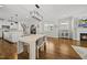 Bright and open dining area with modern lighting and views of the kitchen and living space; perfect for entertaining guests at 398 Carolina Ave, Raleigh, NC 27606