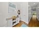 Hallway features hardwood flooring, a window, a cabinet, and hats hanging on the wall at 398 Carolina Ave, Raleigh, NC 27606