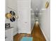 Hallway features hardwood flooring, a window, a cabinet, and hats hanging on the wall at 398 Carolina Ave, Raleigh, NC 27606