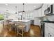 Bright kitchen with white cabinets, quartz countertops, stainless steel appliances, and wood floors at 398 Carolina Ave, Raleigh, NC 27606