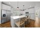 Bright kitchen featuring white cabinets, stainless steel appliances, quartz counters, and a large island at 398 Carolina Ave, Raleigh, NC 27606
