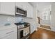 Bright kitchen featuring white cabinets, stainless steel appliances, quartz countertops, and a gas range at 398 Carolina Ave, Raleigh, NC 27606