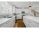 Bright kitchen with white cabinets, quartz countertops, stainless steel appliances, and wood floors at 398 Carolina Ave, Raleigh, NC 27606