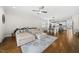 Open-concept living room with a large sectional sofa, hardwood floors, and a view of the kitchen and dining areas; ideal for gatherings at 398 Carolina Ave, Raleigh, NC 27606