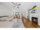 Open-concept living room with hardwood floors, fireplace, and views of the kitchen and dining area; comfortable and stylish at 398 Carolina Ave, Raleigh, NC 27606