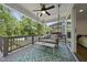 Relaxing back porch with a porch swing, ceiling fan, and an outdoor rug overlooking green trees at 398 Carolina Ave, Raleigh, NC 27606