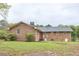 Backyard showcasing the rear of the brick home at 4005 King Charles Rd, Durham, NC 27707