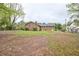 Backyard showcasing the lot and rear elevation of the brick home at 4005 King Charles Rd, Durham, NC 27707