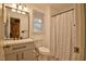 Bathroom featuring a combined shower and tub with patterned curtain and updated vanity at 4005 King Charles Rd, Durham, NC 27707