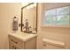 Bright bathroom with modern vanity, sleek fixtures, and natural light from a window at 4005 King Charles Rd, Durham, NC 27707
