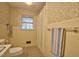 Bathroom with traditional tiling, a shower/tub, and patterned wallpaper at 4005 King Charles Rd, Durham, NC 27707