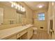 Cozy bathroom featuring neutral tilework, a sink with vanity, and classic fixtures at 4005 King Charles Rd, Durham, NC 27707