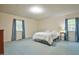 Serene bedroom with neutral walls, two windows, and soft carpeting offering a peaceful retreat at 4005 King Charles Rd, Durham, NC 27707