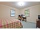 Cozy bedroom with two windows, carpet flooring, and a dedicated workspace at 4005 King Charles Rd, Durham, NC 27707