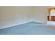Corner bedroom featuring blue carpet and white walls at 4005 King Charles Rd, Durham, NC 27707