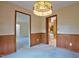 Dining room with a decorative chandelier and wood trim at 4005 King Charles Rd, Durham, NC 27707