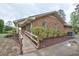 Side view showcasing a brick home with a convenient ramp at 4005 King Charles Rd, Durham, NC 27707