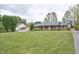 Charming brick ranch with large front yard and mature trees offering curb appeal at 4005 King Charles Rd, Durham, NC 27707