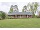 Charming brick home with a covered porch and a spacious front yard at 4005 King Charles Rd, Durham, NC 27707