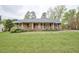 Charming brick ranch with large front yard and mature trees offering curb appeal at 4005 King Charles Rd, Durham, NC 27707