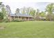 Charming brick ranch with large front yard and mature trees offering curb appeal at 4005 King Charles Rd, Durham, NC 27707