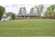 Charming brick ranch with large front yard and mature trees offering curb appeal at 4005 King Charles Rd, Durham, NC 27707