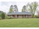 Charming brick ranch with large front yard and mature trees offering curb appeal at 4005 King Charles Rd, Durham, NC 27707