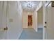 Hallway with multiple doorways and a decorative light fixture at 4005 King Charles Rd, Durham, NC 27707