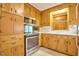 A well-equipped kitchen with warm wood cabinetry, modern stainless steel appliances, and bright countertops at 4005 King Charles Rd, Durham, NC 27707