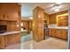 Eat-in kitchen with wooden cabinets and a view to the living room at 4005 King Charles Rd, Durham, NC 27707