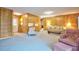 Spacious living room with wood paneling, comfortable seating, and convenient access to the outside patio at 4005 King Charles Rd, Durham, NC 27707