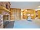 Bright living room featuring a brick fireplace, built-in shelving, and views of the adjacent kitchen area at 4005 King Charles Rd, Durham, NC 27707