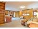 Inviting living room with wood paneling, brick fireplace, built-in bookcases, and plush seating for relaxation at 4005 King Charles Rd, Durham, NC 27707