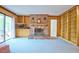 Comfortable living room with sliding glass doors, brick fireplace, built-in bookcases, and ample natural light at 4005 King Charles Rd, Durham, NC 27707