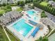An aerial view of the community pool area featuring a lap pool, pool, and ample seating at 4020 Kinsley Trce, Burlington, NC 27215