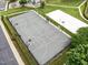Aerial view of a basketball court with volleyball court and surrounding greenery, perfect for outdoor recreation at 4020 Kinsley Trce, Burlington, NC 27215
