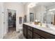 Modern bathroom with double sink vanity, large mirror, tile floor, and a walk-in closet at 4020 Kinsley Trce, Burlington, NC 27215