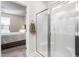 Bathroom featuring tiled shower, neutral walls, chrome hardware and access to the bedroom at 4020 Kinsley Trce, Burlington, NC 27215