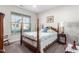 Comfortable bedroom with a wooden bed, side tables and a bright window with shades at 4020 Kinsley Trce, Burlington, NC 27215