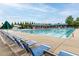 Community pool with many lounge chairs and sun shades for the residents' enjoyment at 4020 Kinsley Trce, Burlington, NC 27215