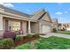 Beautiful home exterior showcasing manicured landscaping, a two-car garage, and inviting front porch at 4020 Kinsley Trce, Burlington, NC 27215