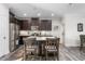 Stylish kitchen featuring an island with seating, stainless steel appliances, and dark wood cabinetry at 4020 Kinsley Trce, Burlington, NC 27215