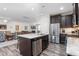 Well-lit kitchen showcases granite countertops, a stainless steel refrigerator, and dark cabinetry at 4020 Kinsley Trce, Burlington, NC 27215