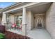 Inviting covered porch with comfortable seating and well-maintained landscaping enhances curb appeal at 4020 Kinsley Trce, Burlington, NC 27215