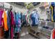 Organized walk-in closet with shelves of shoes and hanging clothes for maximum storage at 4020 Kinsley Trce, Burlington, NC 27215